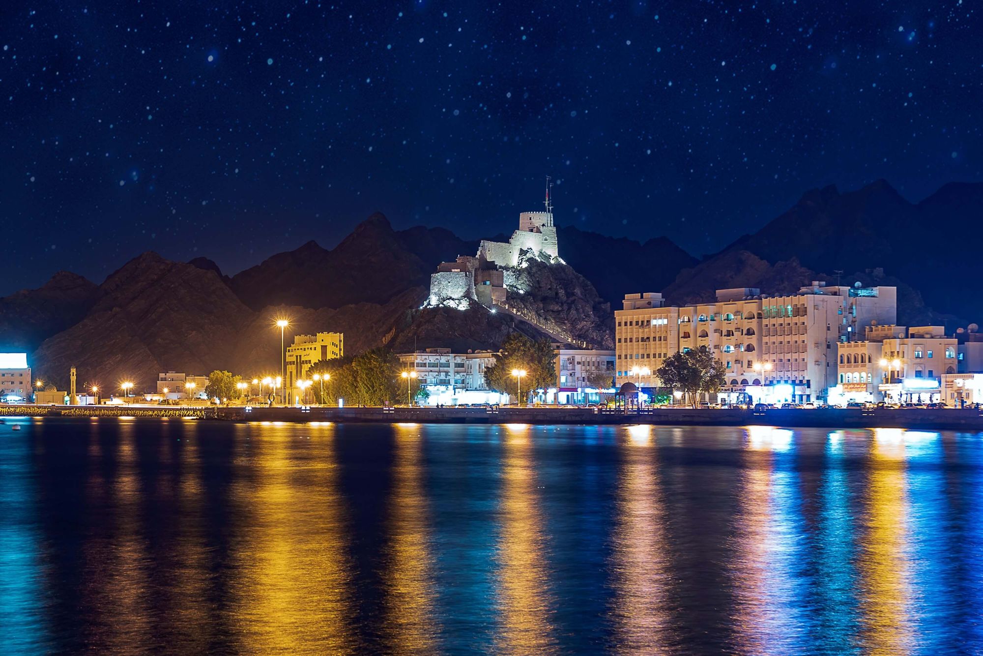 Muscat's seafront lit up at night